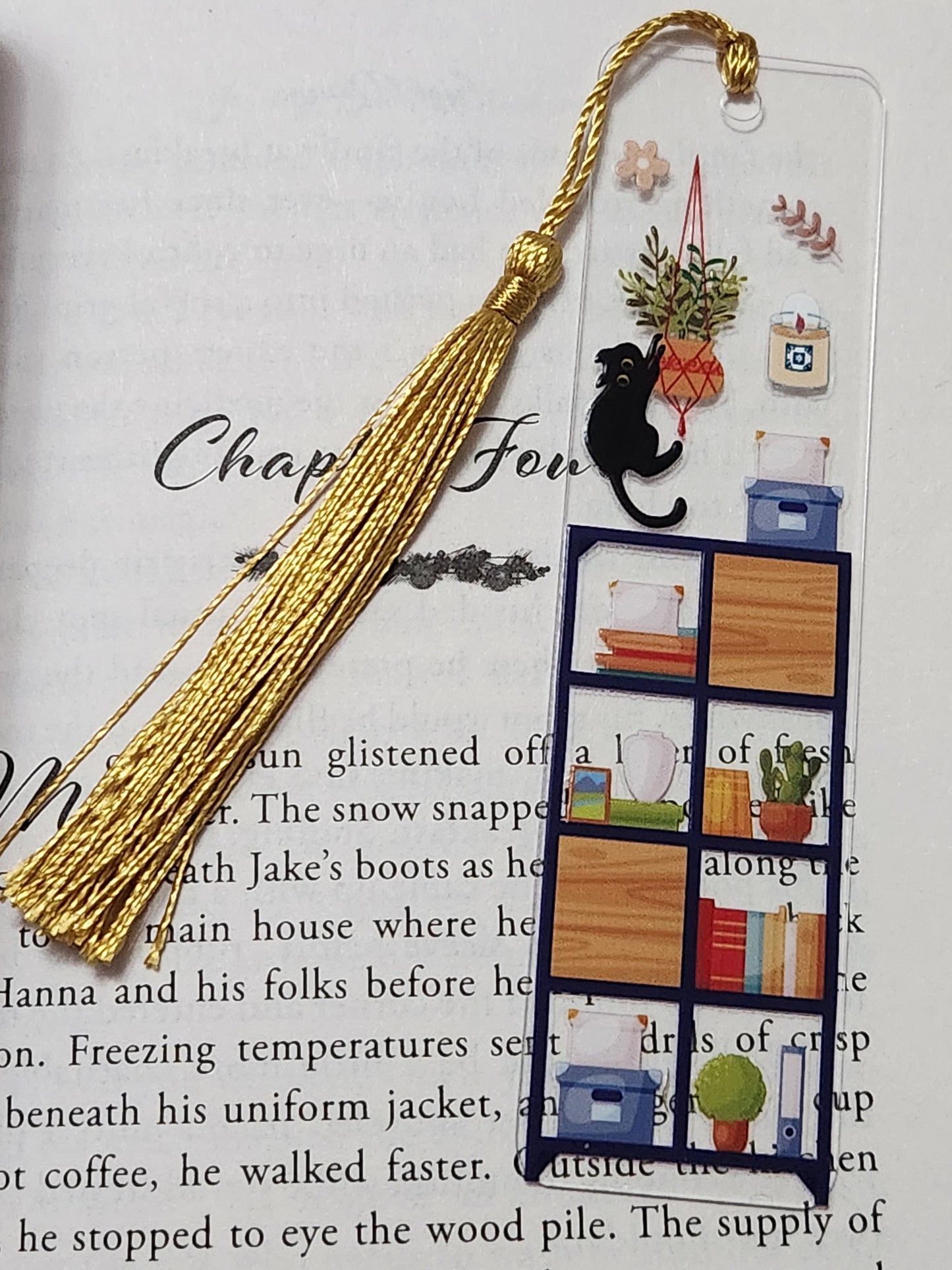 Bookmark: Cat hanging on plant and bookshelf